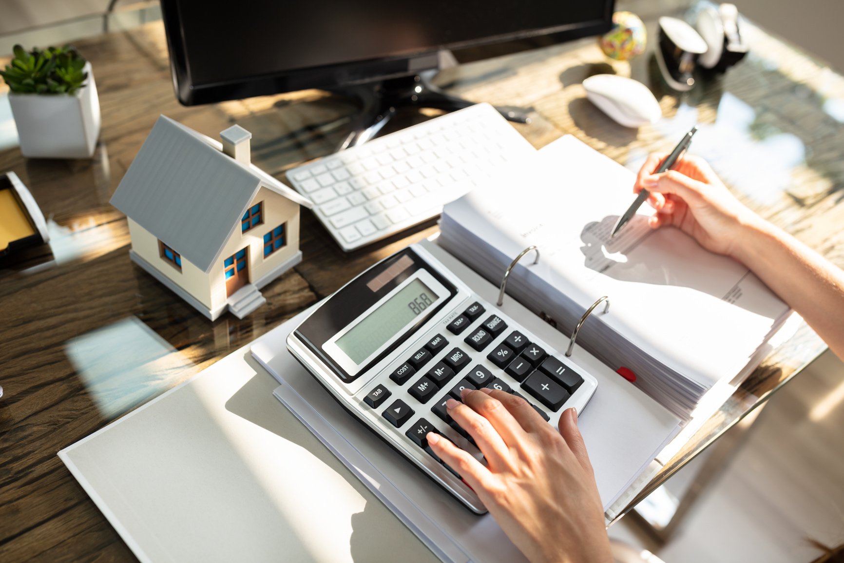 Real Estate Agent Calculating Tax